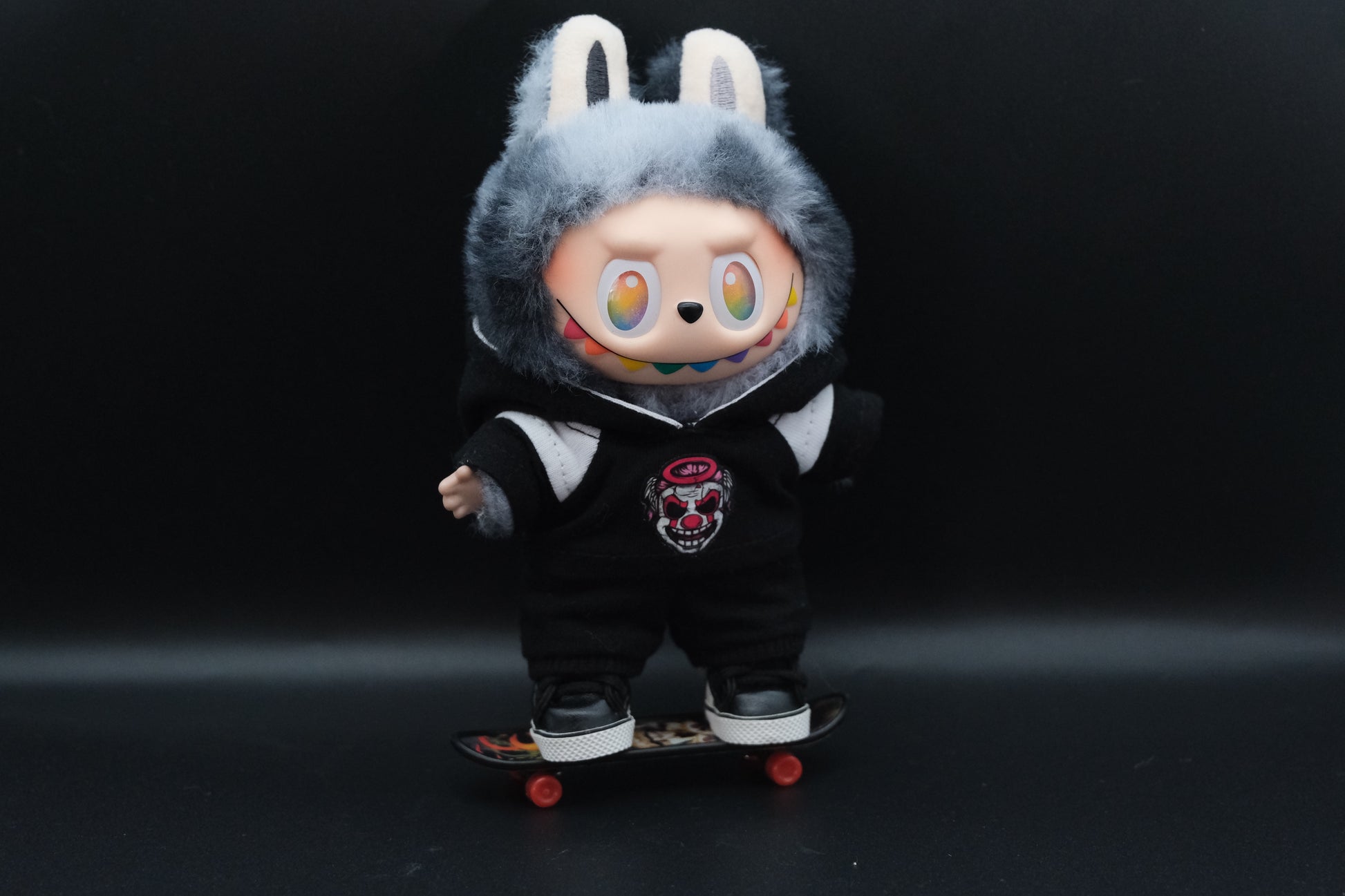  A trendy Labubu designer toy figure wearing a black and white hoodei, pants and black shoes