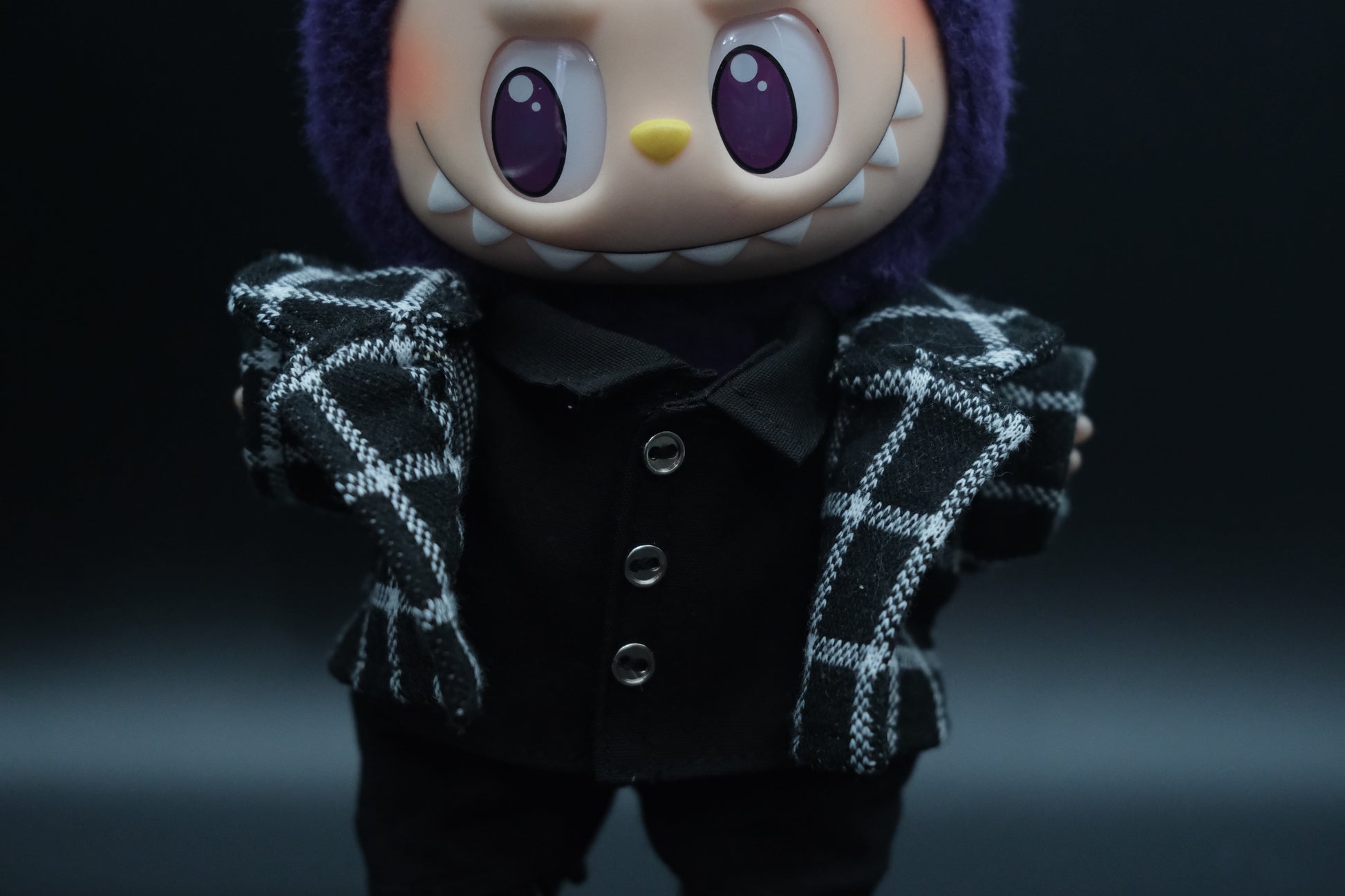 Close-up of a labubu wearing stylish plaid jacket from the streetwear outfit set.
