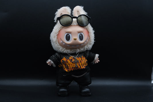 A Labubu figure wearing a sunglasses, mesh shirt, leather pants, black shoes and cross necklace