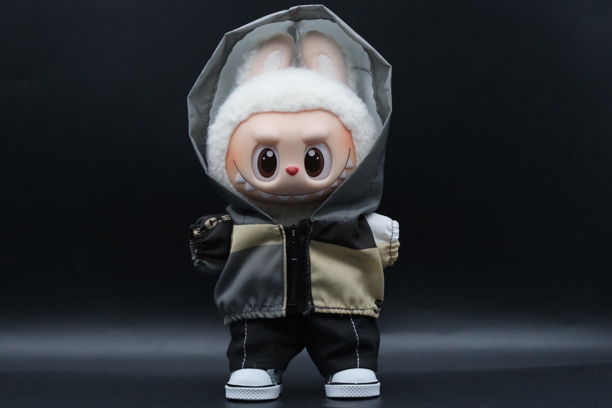  a Labubu figure wearing a functional windbreaker outfit, black pants and shoes