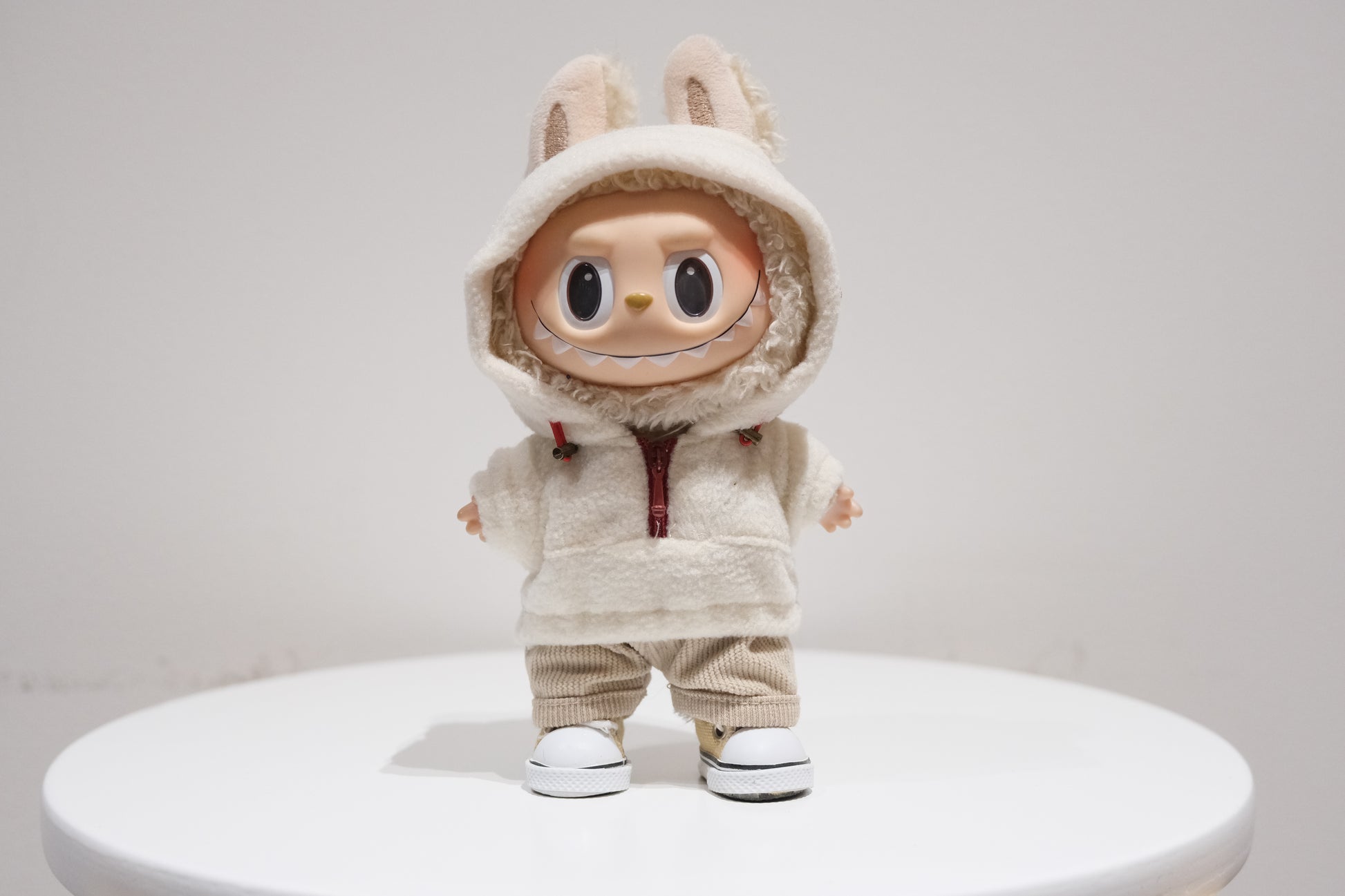 Labubu figure wearing a 3-piece teddy fleece hoodie and pants cozy winter outfit with sneakers
