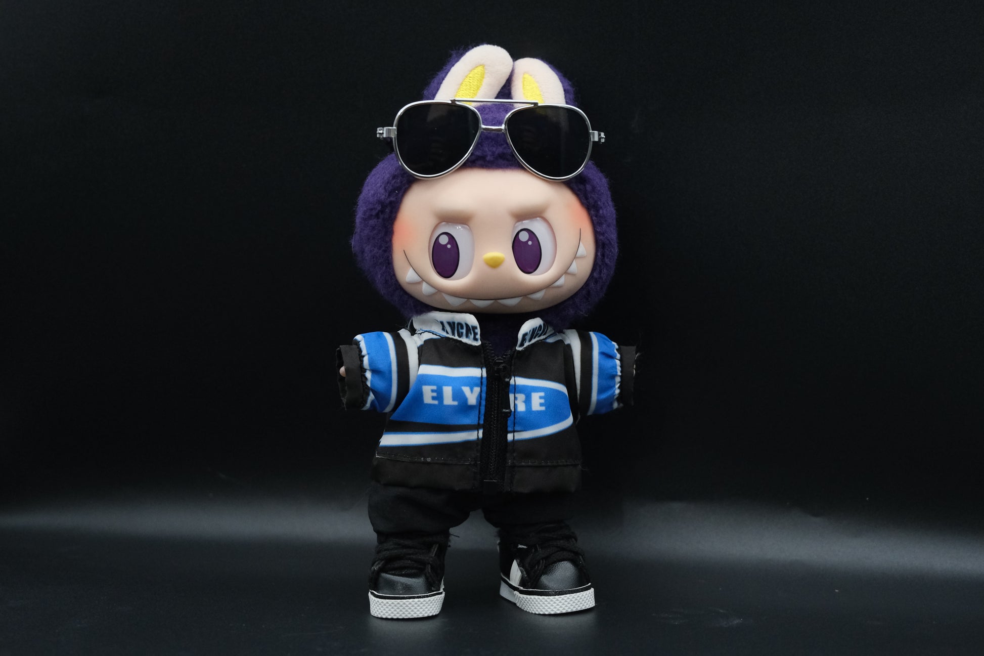 Labubu Vintage Sport Outfit including racing jacket, black pants, shoes and sunglasses
