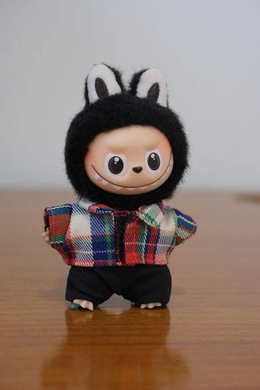 Labubu figure wearing a 2-piece plaid shirt and black pants outfit