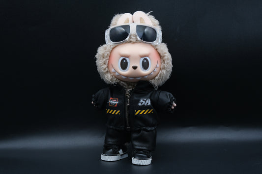 A Labubu designer toy figure in a dark, urban-style outfit, featuring a black leather jacket and pants , sunglasses and a pair of shoes