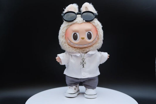 A Labubu figure wearing a 5-piece white outfit, including a shirt, sunglasses, necklace,shoes and pants.