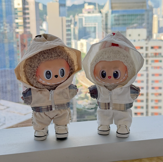 A trendy Labubu designer toy figure wearing a minimalist white zip-up hoodie with a contrasting white zipper, white pants, and stylish white high-top sneakers with black accents.