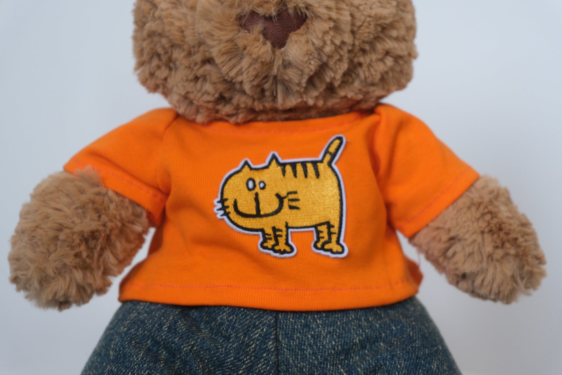 Close-up showing the flexible waistband and denim texture on the jeans for a Jellycat Bear