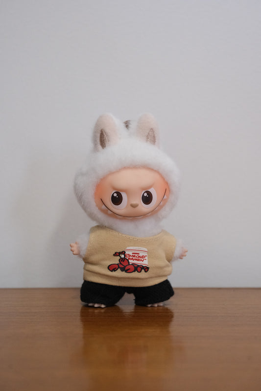 Labubu figure wearing a lobster graphic tank top and black pants.