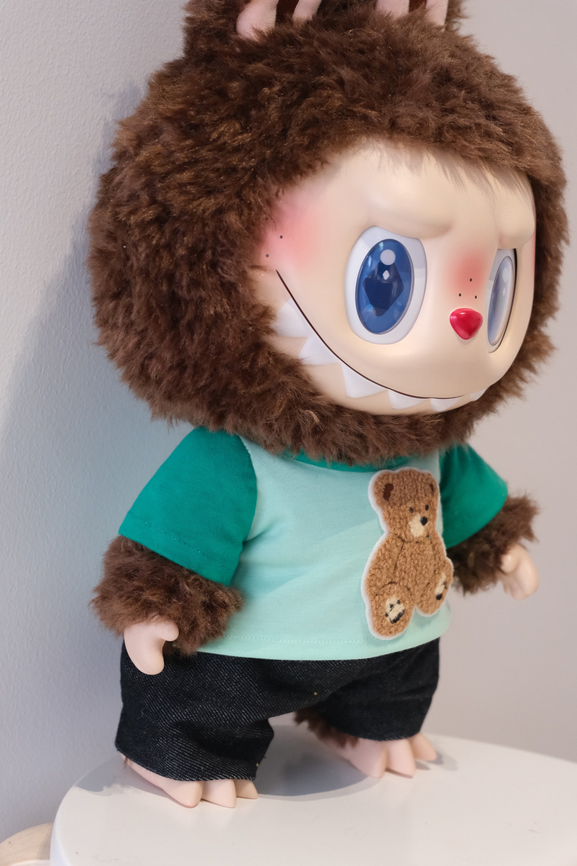 side view of A cute 2-piece Labubu outfit from the Let's Checkmate series featuring soft, multi-tonal color-blocked joggers and a playful graphic T-shirt in a children's streetwear style