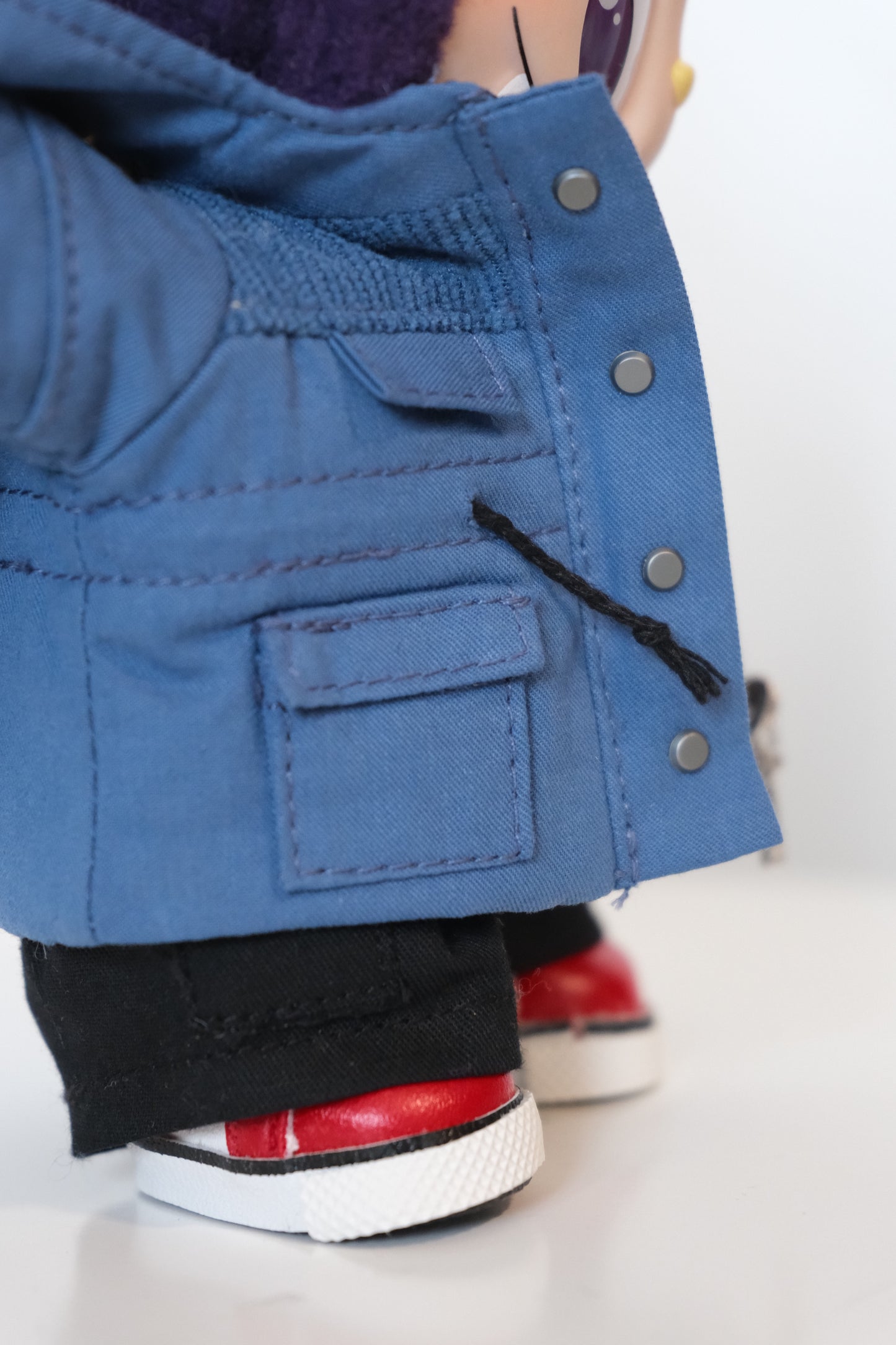 A Labubu figure dressed in a 4-piece red winter mountaineering outfit, including a utility parka with a 'COOL' patch, black pants, and white sneakers.