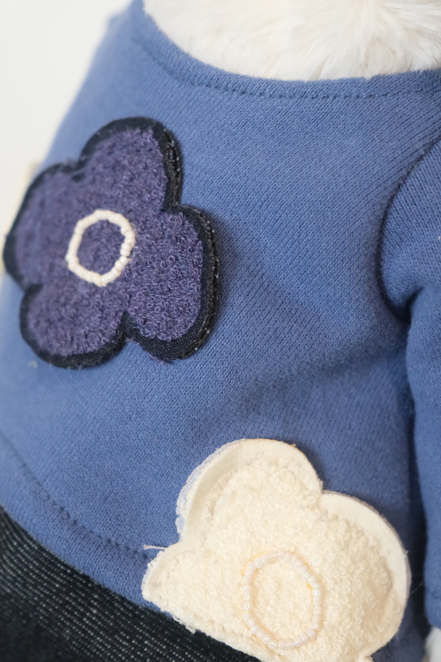 Close-up of the miniature T-shirt and pants set, showing the clean, simple fit on the Jellycat Bunny doll.