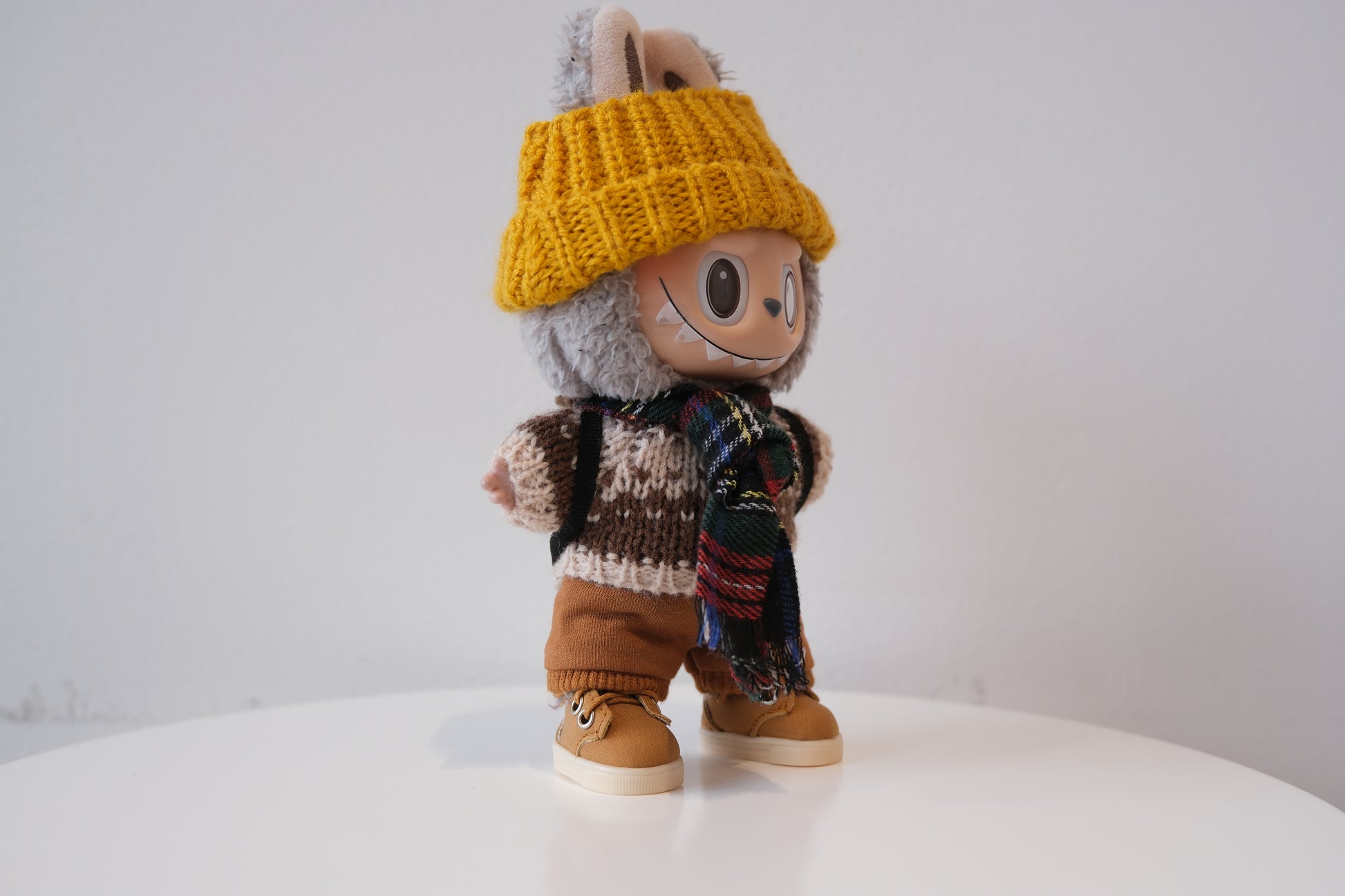 Labubu figure wearing a 5-piece winter knit outfit, including a Fair Isle sweater and yellow beanie