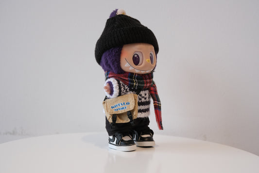 Labubu figure wearing a 6-piece winter streetwear outfit, including a striped knit sweater and black beanie