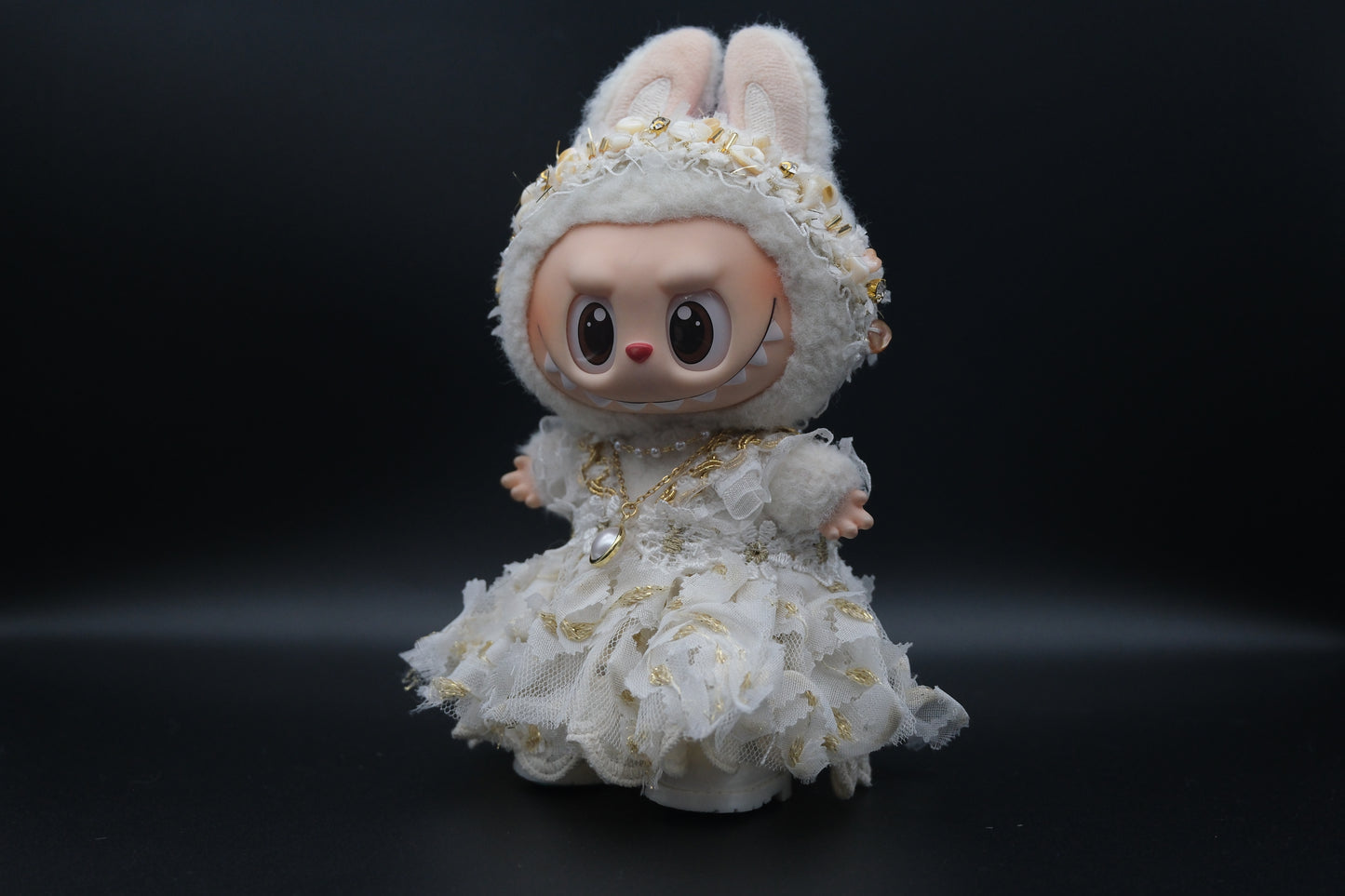 side view of Labubu figure wearing a 3-piece white frill dress, necklace, and shoes, representing the Coquette or Angel Core aesthetic