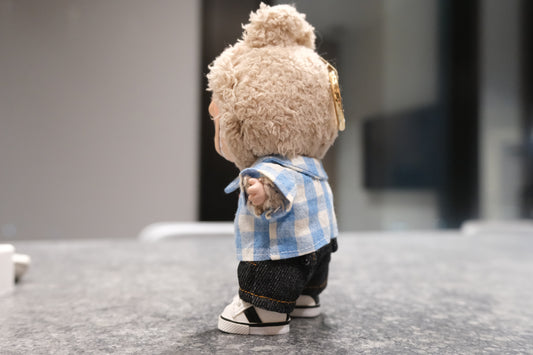 side view of Labubu figure wearing a 3-piece casual outfit with a blue gingham shirt, dark denim shorts, and white sneakers