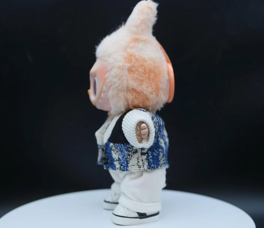 LABUBU plush doll wearing a textured black jacket and black and white plaid pants