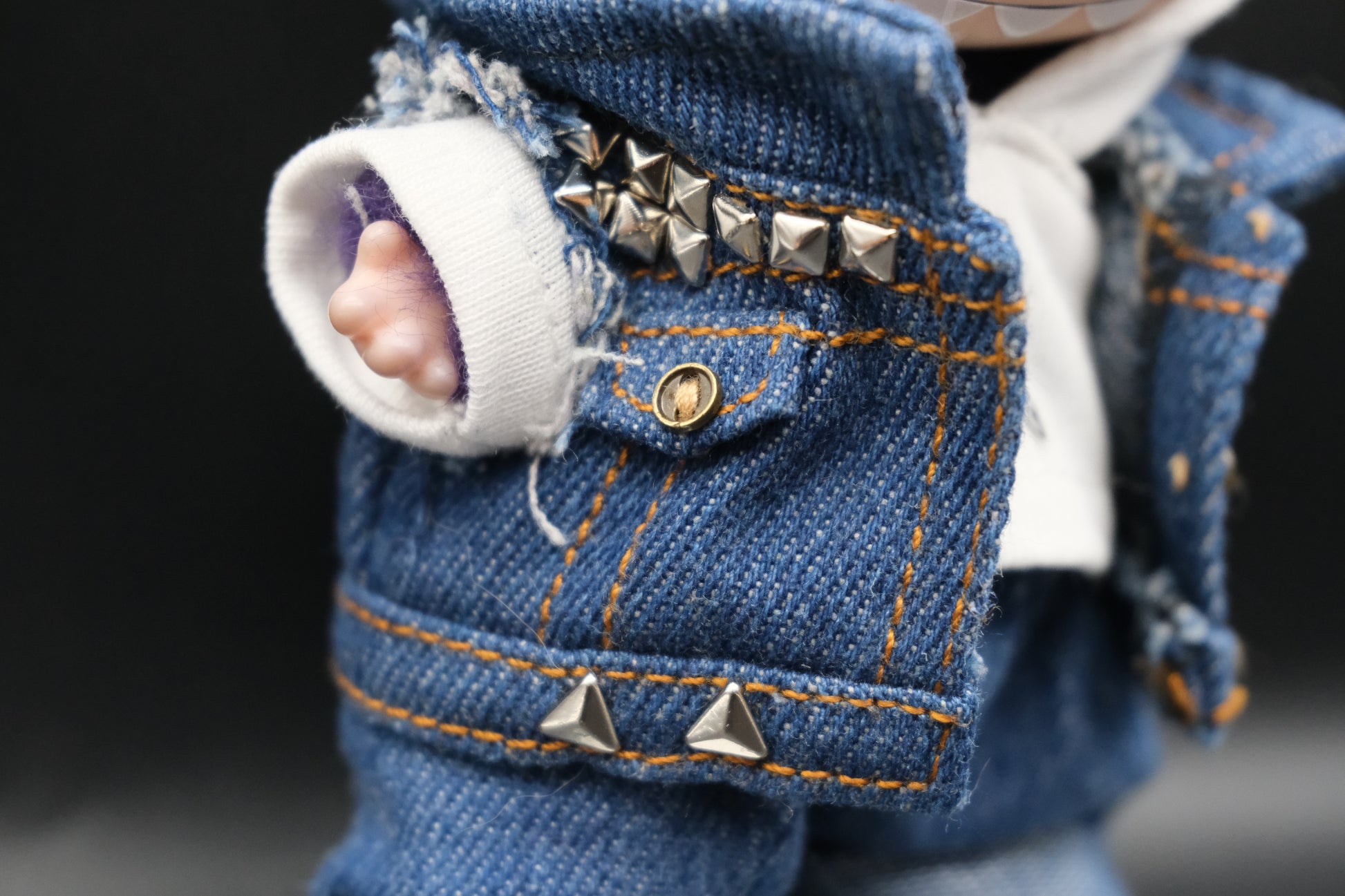 a close up of labubu denim jacket and white hoodie